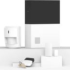 Abode devices like the hub, motion detector, and key fob stand on white shelves against a white background.