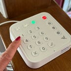 arlo-home-security-system-finger-on-button