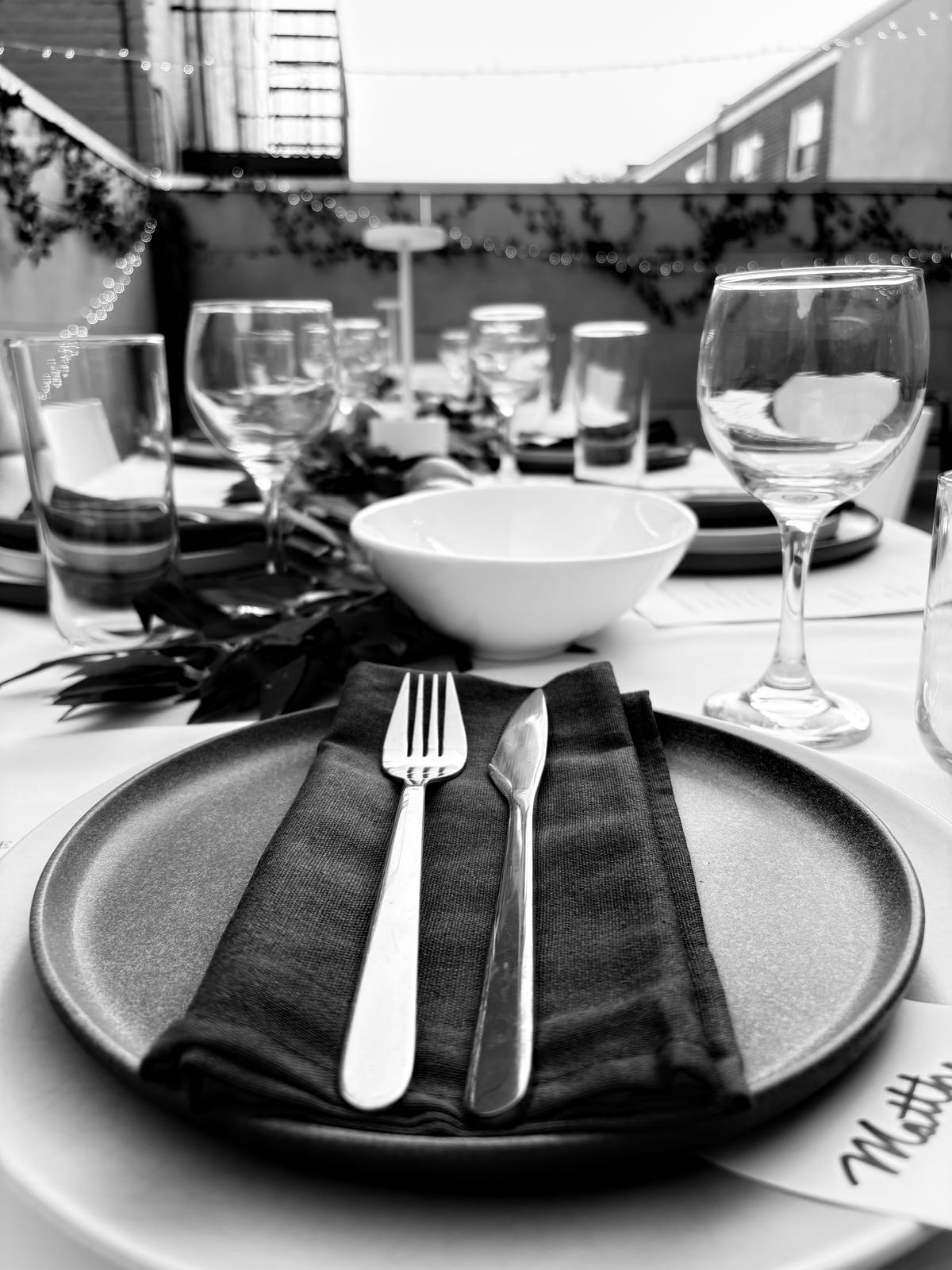 A photo of a place setting at a table in black and white