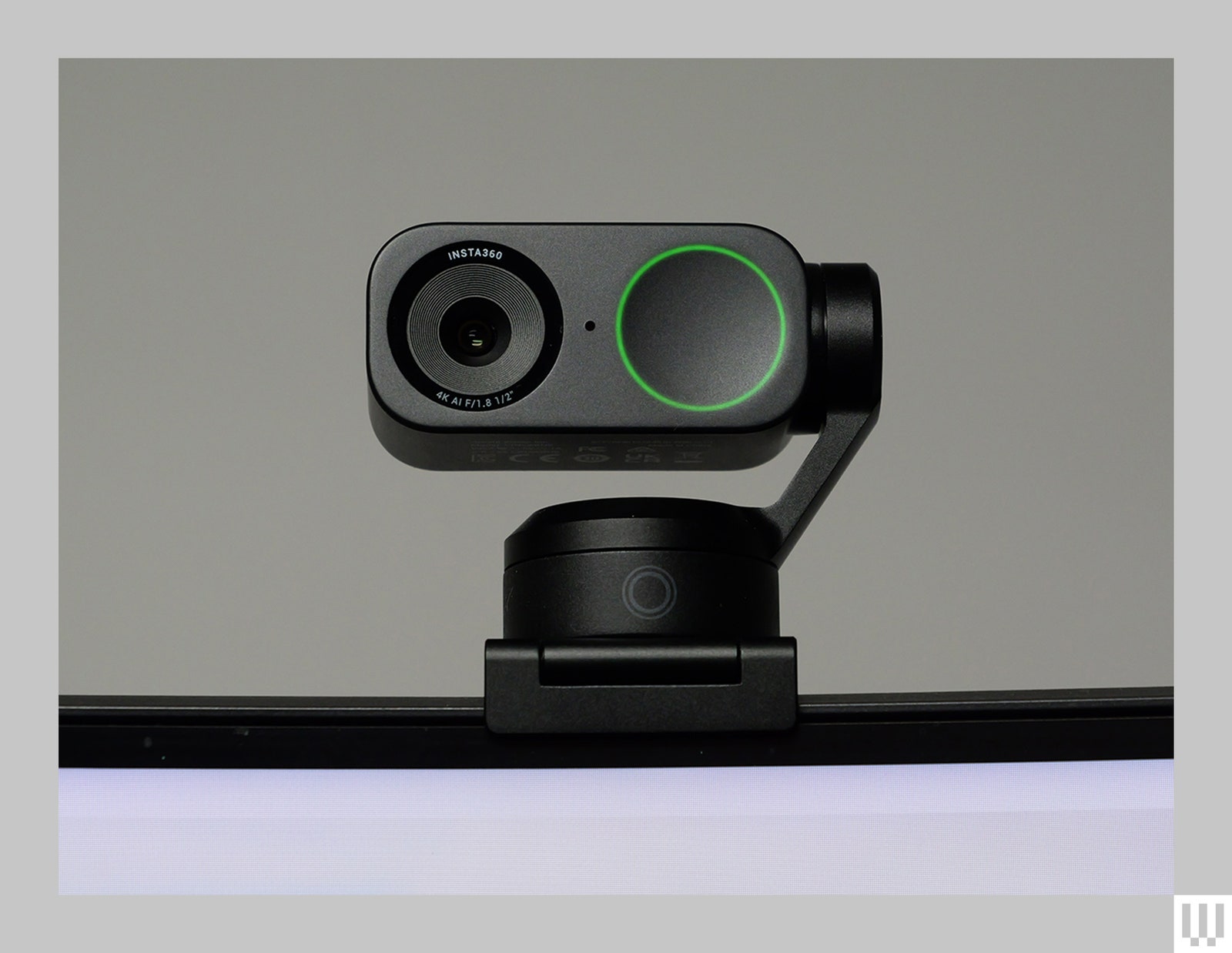 Insta 360 Link 2 a black webcam clipped to the top of a screen