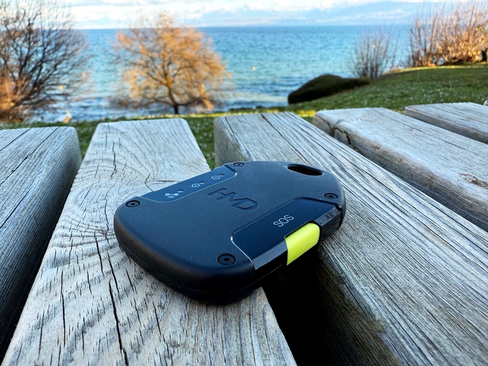 An image of the HMD Off Grid placed on a park bench overlooking the water.