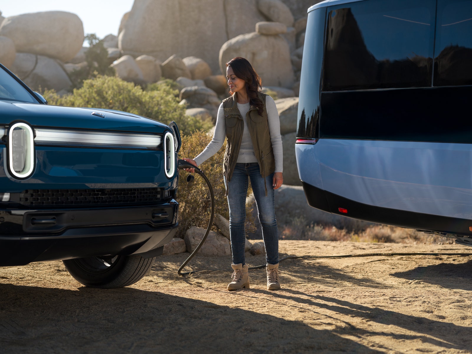 A press image of the new electric RV from Pebble acting as a charging hub for other electric vehicles.