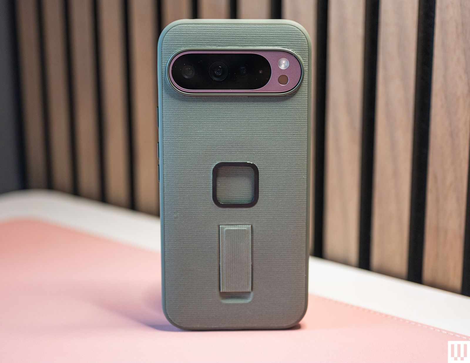 A Peak Design Everyday Case in green on a Pixel 9 phone showing the rear camera of the phone and mount mechanism of the case