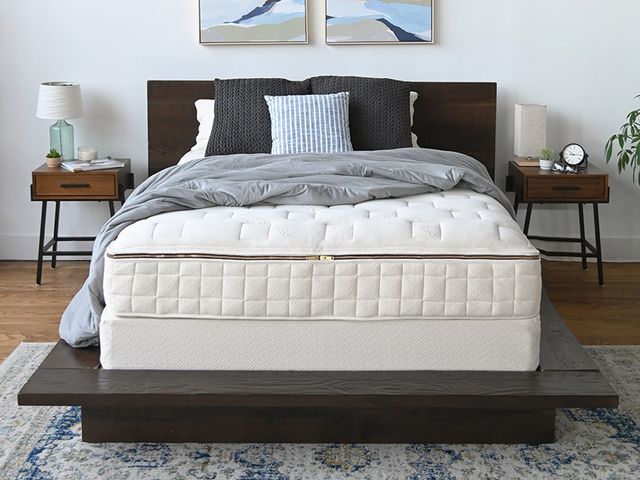Naturepedic EOS Classic Organic Mattress, a thick white mattress on a black minimalist platform bedframe