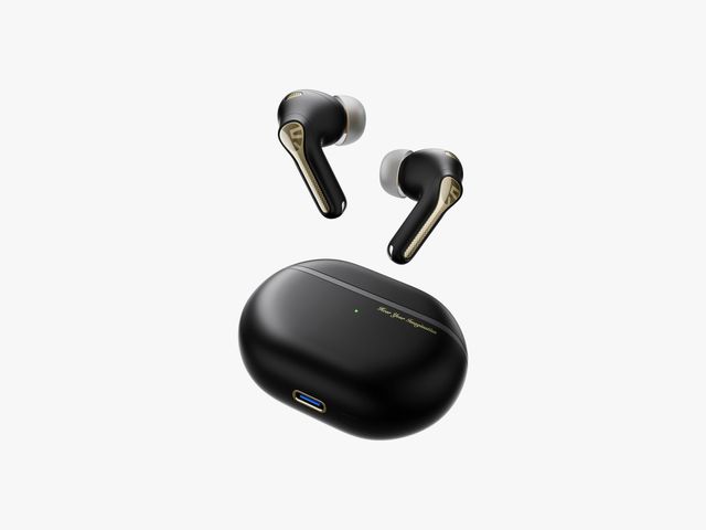 Soundpeats Capsule 3 Pro Plus, black and gold earbuds with white cushions hovering over a closed black oval-shaped case