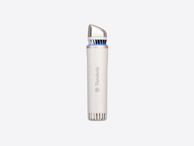 Therabody TheraFace Depuffing Wand, a thick white cylindrical device with a silver top