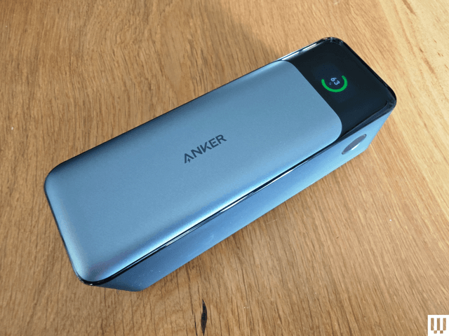 Silver rectangular portable charger with a narrow screen on the end