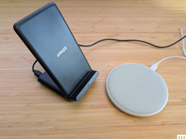 Side view of Anker PowerWave Pad and Stand, a black angled stand beside a white disc-shaped device