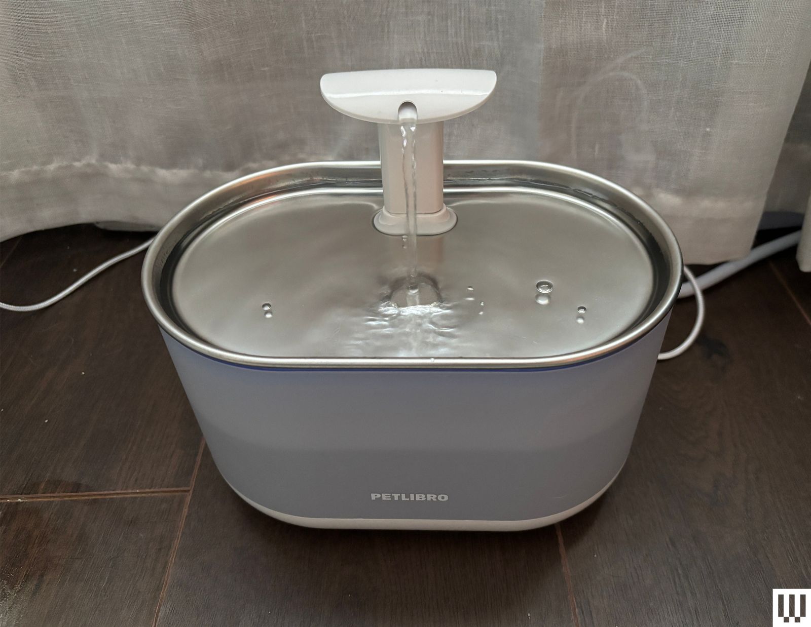 Silver ovalshaped fountain with small spout on top