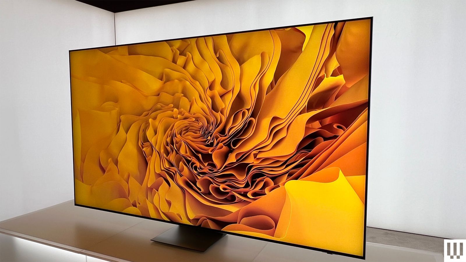 Side view of the Samsung RGB Micro LED TV with the screen showing vibrant yellow folds of abstract art