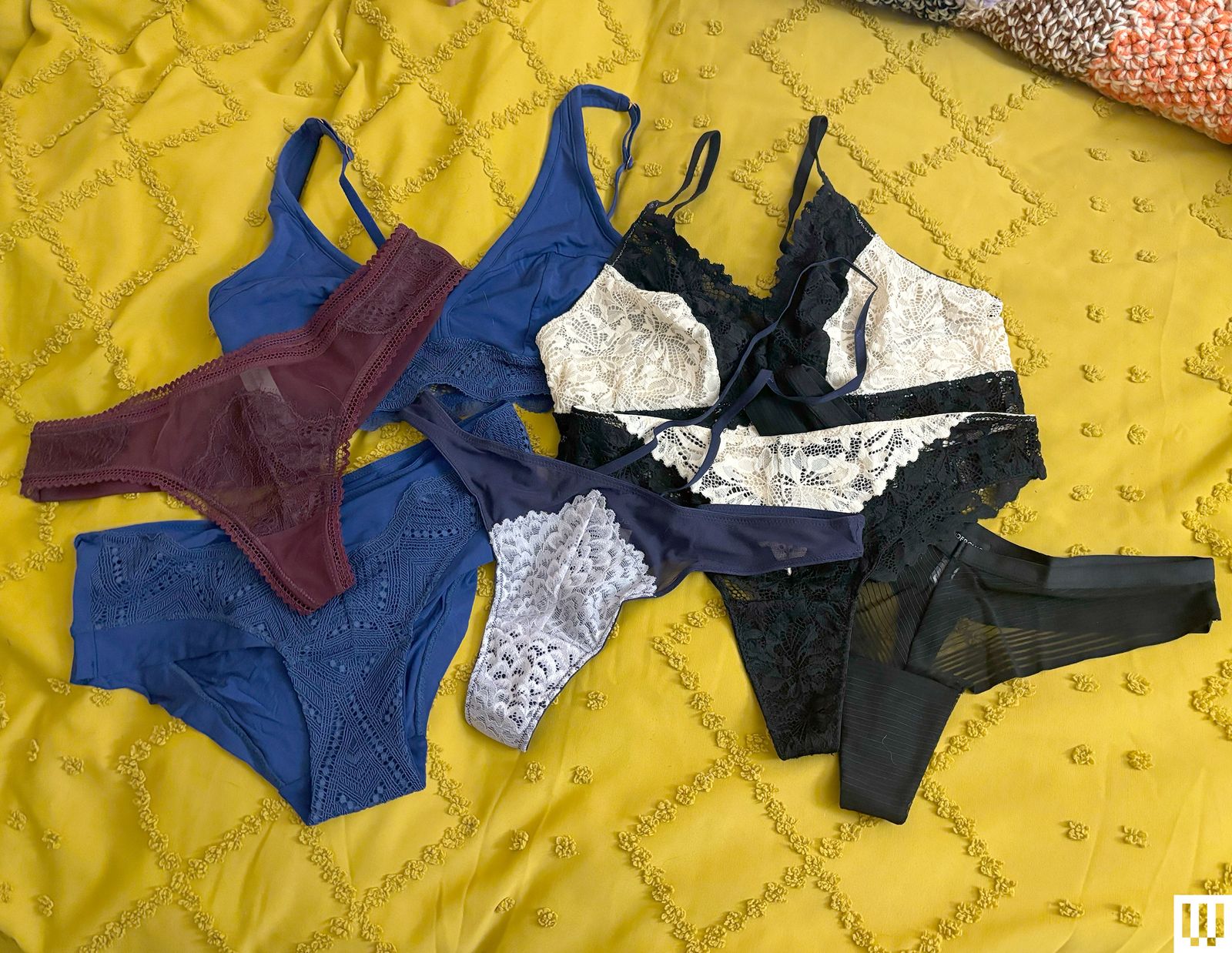 Underwear from the Underclub Subscription Box scattered on a yellow blanket