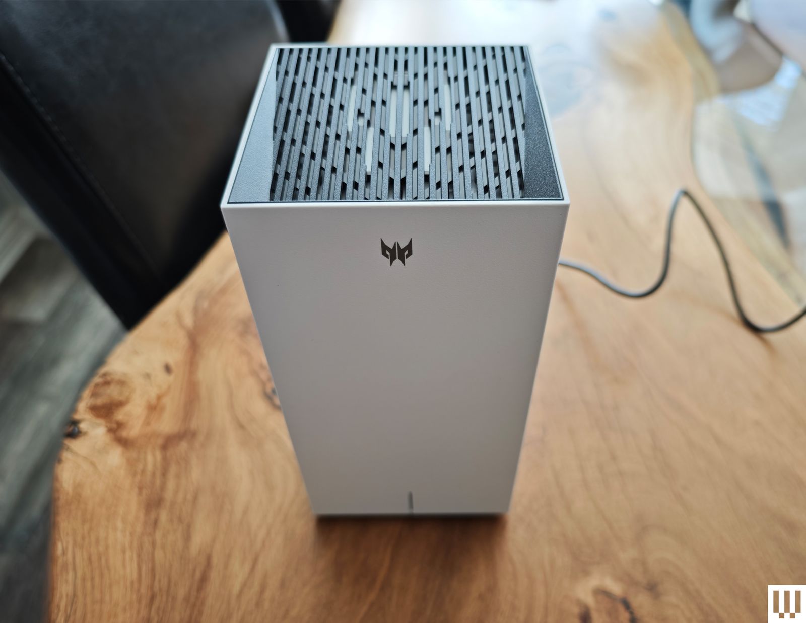 Image may contain Indoors Interior Design Electronics Speaker Hardware Furniture Table and Computer Hardware