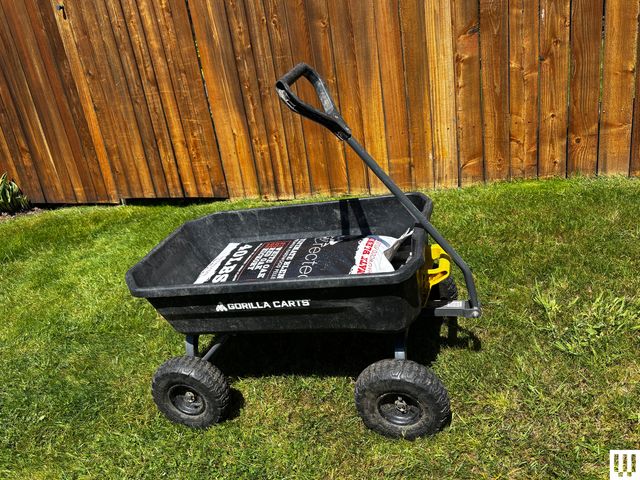 Image may contain: Grass, Plant, Transportation, Vehicle, Wagon, Machine, Wheel, Device, Lawn, Lawn Mower, Tool, and Carriage