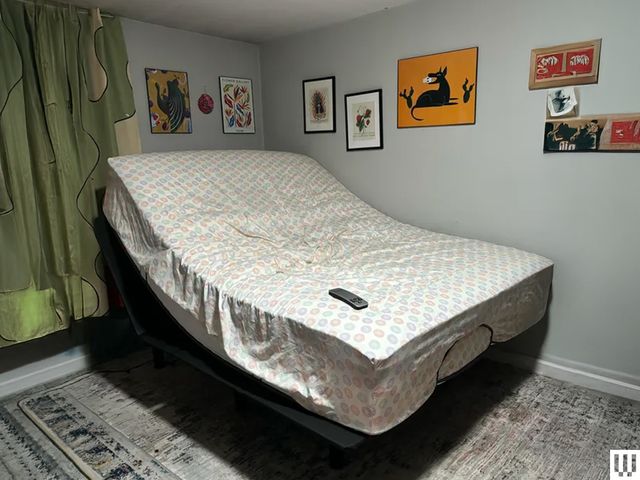 Image may contain: Furniture, Bed, Electronics, Mobile Phone, Phone, Art, and Painting
