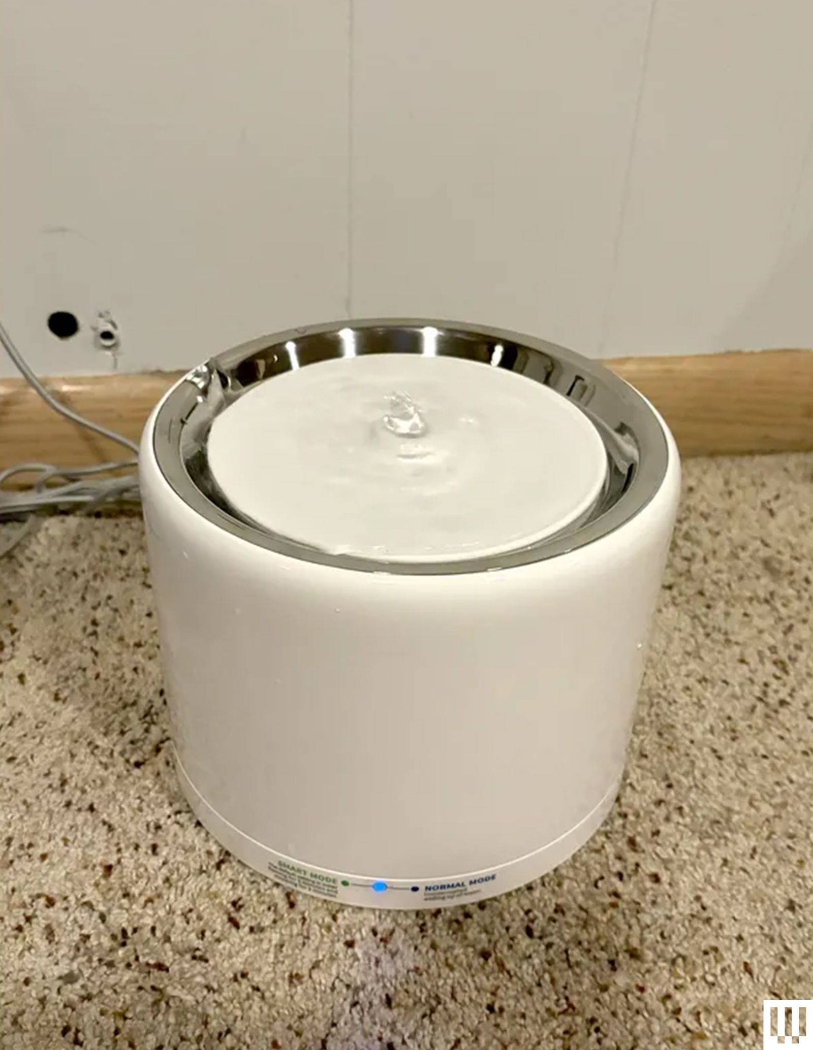Petkit Eversweet 3 Pro a cylindrical water fountain for cats with a circular white disk at top where the water gently...